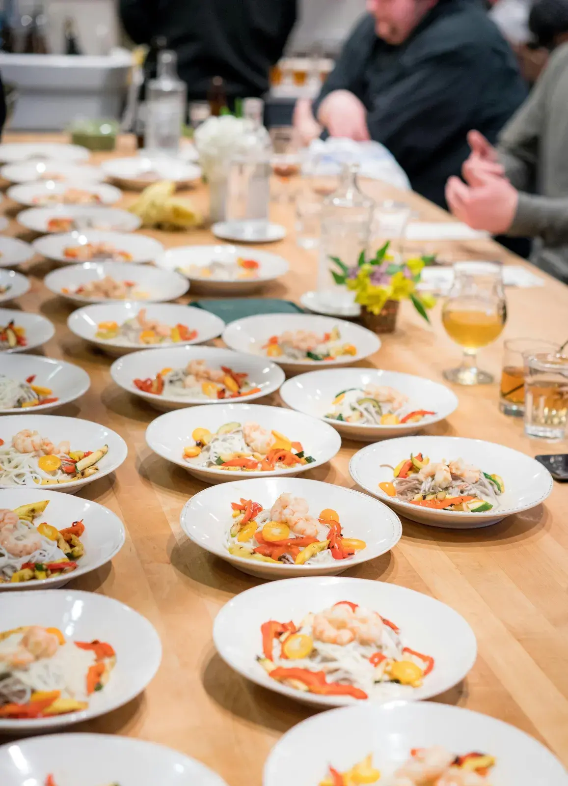 Plated dishes down a long shared table
